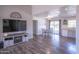 Open concept living area with hardwood floors, TV, fireplace and view to dining area and kitchen at 402 W Mohawk Ln, Phoenix, AZ 85027