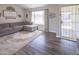 Living room featuring lots of light from large windows and a gray sectional couch on hardwood floors at 402 W Mohawk Ln, Phoenix, AZ 85027