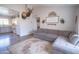 Spacious living room featuring a plush sectional sofa adjacent to the bright kitchen at 402 W Mohawk Ln, Phoenix, AZ 85027