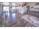 Open floor plan featuring living room, kitchen, and dining room with hardwood floors and neutral paint at 402 W Mohawk Ln, Phoenix, AZ 85027