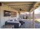Covered patio with comfortable seating and outdoor TV, perfect for relaxing and enjoying the backyard at 402 W Mohawk Ln, Phoenix, AZ 85027