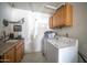Functional utility room with storage cabinets and laundry appliances at 402 W Mohawk Ln, Phoenix, AZ 85027