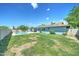 Large backyard with sparkling pool, well-maintained lawn, and solar panels on roof at 4023 W Joan De Arc Ave, Phoenix, AZ 85029