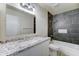 The bathroom features tiled walls, granite countertops, and modern fixtures at 4023 W Joan De Arc Ave, Phoenix, AZ 85029