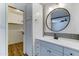 Bathroom featuring vanity, round mirror, modern lighting and storage at 4023 W Joan De Arc Ave, Phoenix, AZ 85029