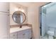 Bathroom featuring vanity, round mirror, modern lighting and tiled shower at 4023 W Joan De Arc Ave, Phoenix, AZ 85029