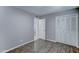 This comfortable bedroom has new floors, light grey walls, and a closet at 4023 W Joan De Arc Ave, Phoenix, AZ 85029