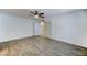 This bedroom boasts new floors, a ceiling fan, and a double door leading to the hallway at 4023 W Joan De Arc Ave, Phoenix, AZ 85029