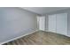 This comfortable bedroom has new floors, light grey walls, and a closet at 4023 W Joan De Arc Ave, Phoenix, AZ 85029