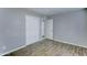 This comfortable bedroom has new floors, light grey walls, and a closet at 4023 W Joan De Arc Ave, Phoenix, AZ 85029