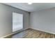 This comfortable bedroom has new floors, light grey walls, and a window for natural light at 4023 W Joan De Arc Ave, Phoenix, AZ 85029