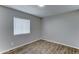 This comfortable bedroom has new floors, light grey walls, and a window for natural light at 4023 W Joan De Arc Ave, Phoenix, AZ 85029