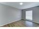 This comfortable bedroom has new floors, light grey walls, and a window for natural light at 4023 W Joan De Arc Ave, Phoenix, AZ 85029