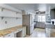 Bright kitchen with stainless steel appliances, granite countertops, plenty of storage space, and a view to the backyard at 4023 W Joan De Arc Ave, Phoenix, AZ 85029