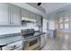 Well-equipped kitchen boasting stainless steel appliances, gray cabinets, and granite countertops at 4023 W Joan De Arc Ave, Phoenix, AZ 85029