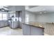 Open kitchen featuring gray cabinets, stainless steel appliances, a kitchen island, and adjacent dining area at 4023 W Joan De Arc Ave, Phoenix, AZ 85029