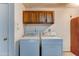 Functional laundry room with updated cabinets and appliances at 4023 W Joan De Arc Ave, Phoenix, AZ 85029