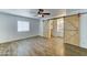 Bright bedroom featuring wood-look flooring, modern ceiling fan, and sliding barn doors at 4023 W Joan De Arc Ave, Phoenix, AZ 85029