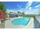 Beautiful backyard featuring a refreshing pool, green grass, and modern solar panels at 4023 W Joan De Arc Ave, Phoenix, AZ 85029
