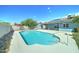 This backyard features a sparkling pool, patio area, and solar panels on the roof at 4023 W Joan De Arc Ave, Phoenix, AZ 85029