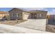 Charming single-story home with a well-maintained front yard and a two car garage at 4051 N Ghost Hollow Way, Casa Grande, AZ 85122