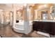 Well-lit bathroom showcasing a large soaking tub, dual vanities, and neutral tiling at 4125 W Lydia Ln, Phoenix, AZ 85041