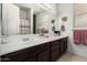 Well-lit bathroom with a double sink vanity and framed mirrors at 4125 W Lydia Ln, Phoenix, AZ 85041