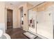 Spacious bathroom featuring a glass-enclosed shower, soaking tub, and tiled floors at 4125 W Lydia Ln, Phoenix, AZ 85041