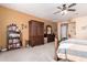 Bright bedroom featuring a large wardrobe, a bookcase filled with books, and comfortable carpet at 4125 W Lydia Ln, Phoenix, AZ 85041
