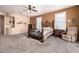 Spacious primary bedroom featuring an ornate bed frame, neutral color palette, and a cozy sitting area at 4125 W Lydia Ln, Phoenix, AZ 85041