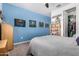 Comfortable bedroom with light-colored carpet, blue walls, and ceiling fan at 4125 W Lydia Ln, Phoenix, AZ 85041