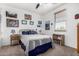 Bedroom featuring a comfortable bed, a side table, and a bookshelf under a shuttered window at 4125 W Lydia Ln, Phoenix, AZ 85041