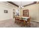 Charming dining area with a wooden table set, traditional decor, and plenty of natural light filtering through the windows at 4125 W Lydia Ln, Phoenix, AZ 85041