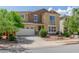 Charming two-story house with a small balcony, well-kept landscaping, and an attached three-car garage at 4125 W Lydia Ln, Phoenix, AZ 85041