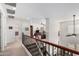 Upstairs hallway with wood banister overlooking living area and access to the bedrooms at 4125 W Lydia Ln, Phoenix, AZ 85041
