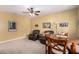 Comfortable living area featuring carpeted floors, ceiling fan, natural light and casual seating at 4125 W Lydia Ln, Phoenix, AZ 85041
