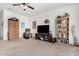Open-concept living room with a large TV, bookshelves, and plush seating at 4125 W Lydia Ln, Phoenix, AZ 85041