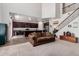 Open-concept living area showcasing modern kitchen, grand staircase, and a comfortable seating area creating seamless flow at 4125 W Lydia Ln, Phoenix, AZ 85041
