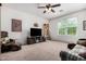Spacious living room with neutral carpeting, ceiling fan, and lots of natural light at 4125 W Lydia Ln, Phoenix, AZ 85041