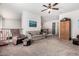 Open upstairs living room features carpet, ceiling fan, and seating at 4125 W Lydia Ln, Phoenix, AZ 85041