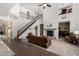 Bright living room featuring high ceilings, large staircase, stone fireplace, and an open layout for modern living at 4125 W Lydia Ln, Phoenix, AZ 85041