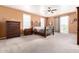 A spacious main bedroom features a ceiling fan, neutral walls and carpet with outdoor access at 4125 W Lydia Ln, Phoenix, AZ 85041