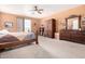 The main bedroom features a ceiling fan, neutral walls and carpet, and traditional furnishings at 4125 W Lydia Ln, Phoenix, AZ 85041