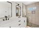 Contemporary bathroom with dual marble countertop vanities and glass enclosed shower at 438 E Hackamore St, Mesa, AZ 85203