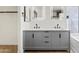 Modern bathroom with dual sinks, gray cabinets, illuminated mirrors, and updated fixtures at 438 E Hackamore St, Mesa, AZ 85203