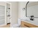 Updated powder room featuring wood vanity with modern hardware and stylish mirror at 438 E Hackamore St, Mesa, AZ 85203
