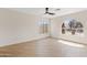 Bright bedroom with wood floors, ceiling fan, and large windows with neighborhood views at 438 E Hackamore St, Mesa, AZ 85203