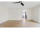 A light and airy bedroom with wood floors, an archway entrance, and a sliding glass door to the outside at 438 E Hackamore St, Mesa, AZ 85203