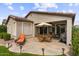 Outdoor patio space features an umbrella table set, with lush landscaping perfect for relaxing at 4517 E Sourwood Dr, Gilbert, AZ 85298