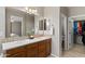 Large bathroom with double sink vanity and a view into the bedroom at 4517 E Sourwood Dr, Gilbert, AZ 85298